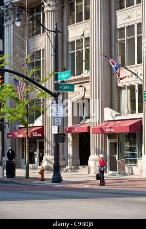 Senior woman waits at intersection of High Street and Gay Street in downtown Columbus, Ohio. Stock Photo