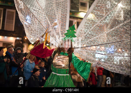 A dancer leads a procession as Christmas celebrations get underway at Ambleside in Cumbria, UK.  Crowds watched as real reindeer and characters in spectacular costumes led a parade of around 200 children carrying lanterns as the Christmas lights were tuned on in the town on Saturday 19th of Nov Stock Photo