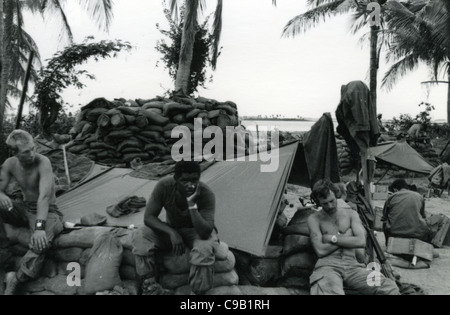 soldiers resting next to sandbags bunkers. 101st ABN in the Ashau Valley during the Vietnam War. Stock Photo