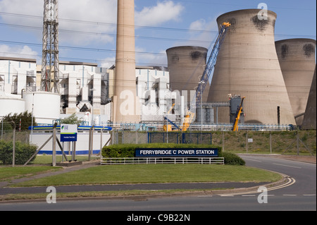 Main entrance to Ferrybridge 'C' Power Station (large name signs, industrial buildings & cooling towers) - Knottingley, West Yorkshire, England, UK. Stock Photo