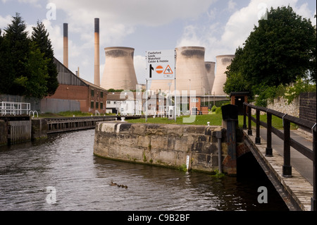 Cooling towers & chimneys of Ferrybridge 'C' Power Station & sign giving directions by Aire and Calder Navigation Canal - West Yorkshire, England, UK. Stock Photo