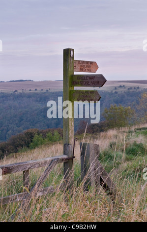 Wooden fingerpost marking Cleveland Way National Trail in beautiful hilltop location with scenic panorama beyond - Sutton Bank, Yorkshire,  England. Stock Photo