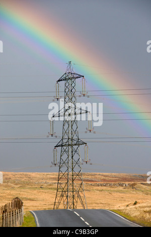 Pylon carrying electricity on Mynydd Llangattock Brecon Beacons with rainbow behind Near Ebbw Vale South Wales UK Stock Photo