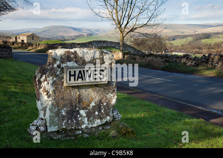 Road Sign Hawes Aluminium Corroded Village Boundary Sign in the Yorlshire Dales, Richmondshire district of North Yorkshire, England Stock Photo