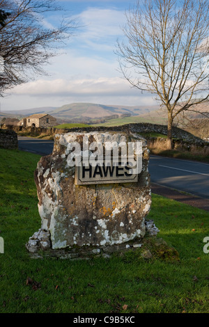 Road Sign Hawes Aluminium Corroded Village Boundary Sign in the Yorlshire Dales, Richmondshire district of North Yorkshire, England Stock Photo