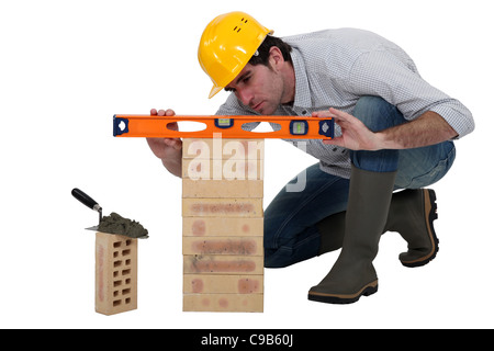 Tradesman using a spirit level Stock Photo