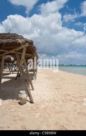 Sun shades on a deserted beach in Hammamet, Tunisia Stock Photo