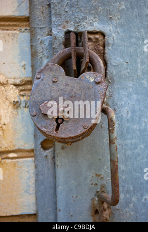 Rusty padlock on an old metal door Stock Photo