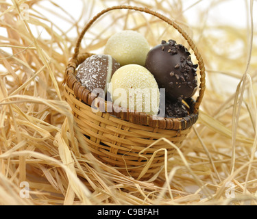 assortment of chocolate eggs in a basket, close up Stock Photo