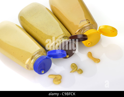 plastic bottles of honey ,dijon and spicy brown mustard Stock Photo