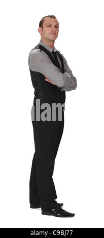 Young confident businessman standing up against a white background. Stock Photo