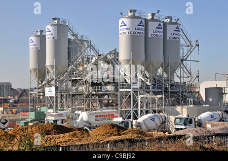 London Concrete industrial site & distribution depot cement silo aggregate storage & delivery mixer lorry trucks Stratford East London England UK Stock Photo