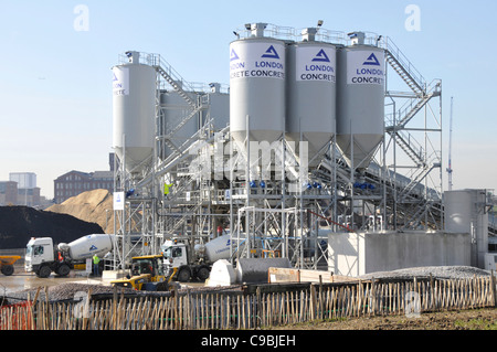 London Concrete industrial site distribution depot with cement silos aggregate storage & mixer delivery lorry trucks Stratford East London England UK Stock Photo