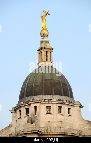 Bronze statue sculpture Lady Justice or Scales of Justice above new copper roof dome Old Bailey courthouse Central Criminal Court City of London UK Stock Photo