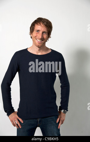 Man standing against white background, smiling, portrait Stock Photo