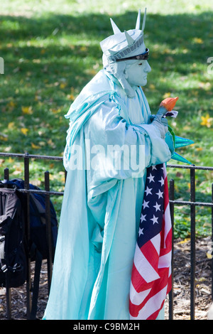 Person dressed as the Statue of Liberty for the Tourists in New York City in Battery Park USA Stock Photo