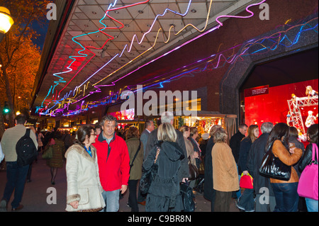 Paris, France, Crowd of Tourists, Enjoying Christmas Lights, decorations, Shopping at 'Galeries Lafayette' Department Store walking on Sidewalk at night, Parisian street scene people, city colour Stock Photo