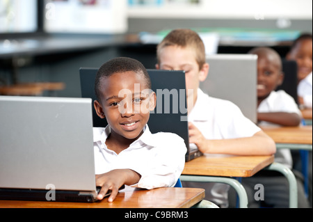 Portrait of boy working on laptop computer in classroom, Johannesburg, Gauteng Province, South Africa Stock Photo