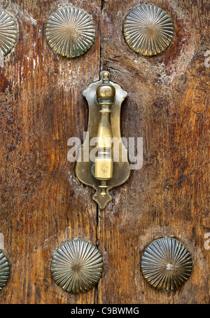 Door knocker and decoration on very old door in Ronda, Andalucia, Spain Stock Photo