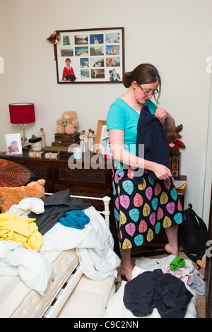 Young lady sorting through laundry at home Stock Photo