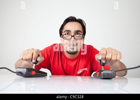 Nerd playing with two retro joystick controllers Stock Photo