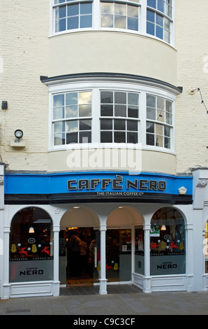 Winchester, Hampshire, England - branch of Caffe Nero coffee shop in an old Georgian building with large bay windows. Stock Photo