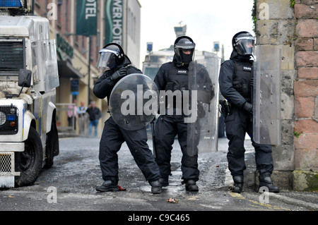 PSNI officers with riot shields and batons during disturbances in the ...