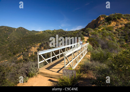 CALIFORNIA - Hiker on bridge on the Backbone Trail in the Topanga State Park section of the Santa Monica Mountains. Stock Photo