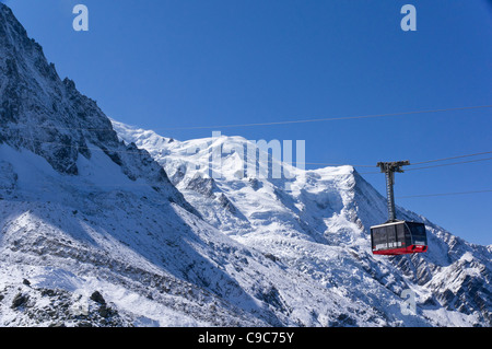 A cable car departs from the Plan de l'Aiguille for the  final ascent to the to the summit cable car station Stock Photo