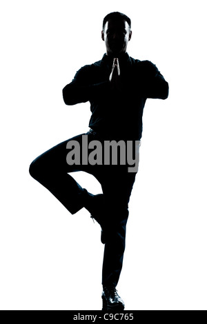 one caucasian business man yoga tree pose  full length silhouette in studio isolated white background Stock Photo