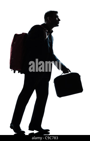 one  business traveler man walking with suitcase on shoulders full length silhouette in studio isolated white background Stock Photo