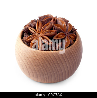 Wooden bowl full of anise stars isolated on white background Stock Photo