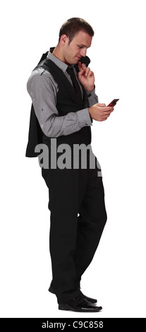 Young businessman checking his mobile phone,isolated against a white background. Stock Photo
