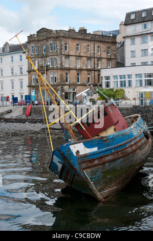 An old fishing boat moored at the quay on the North Pier of the harbour in the middle of Oban, Scotland Stock Photo
