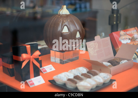 Belgium chocolate shop window display in Brussels with Halloween display showing a chocolate pumpkin Stock Photo