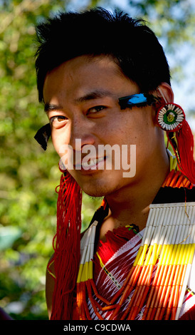 India, South Asia, Nagaland, Naga Warrior tribe man in traditional costume and feather headdress. Stock Photo