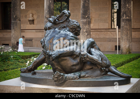 Bronze sculpture in front of Neues Museum - A man fighting with lion. Berlin, Germany. Stock Photo