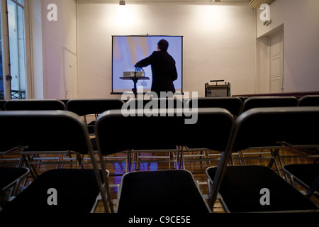 Person preparing overhead projector in conference room Stock Photo