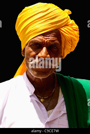 India South Asia Karnataka Lambani Gypsy man wearing yellow turban Tribal forest dwellers now settled in 30-home rural hamlets. Stock Photo