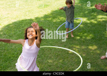 Girl playing with plastic hoop Stock Photo