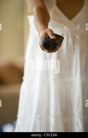 Girl aiming wireless video game controller, cropped Stock Photo