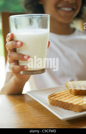 Child holding glass of milk, cropped Stock Photo