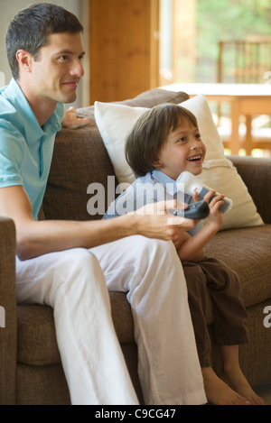 Father and son playing video game together Stock Photo