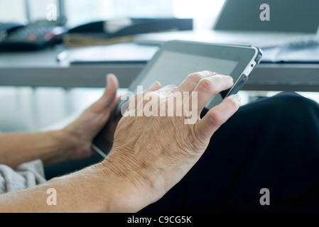 Woman's hand touching digital tablet screen Stock Photo