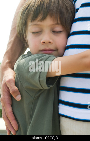 Boy embracing his father, close-up Stock Photo