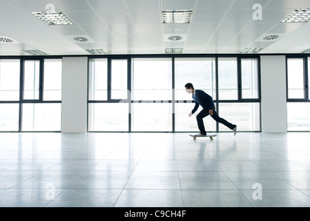 Man skateboarding indoors Stock Photo