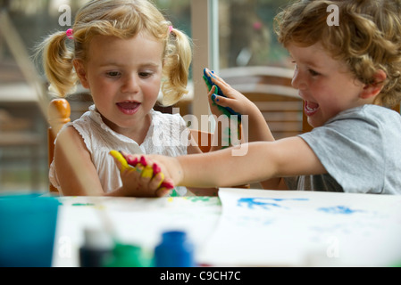 Children playing with paint together Stock Photo