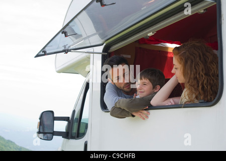 Parents and young son by motor home window Stock Photo