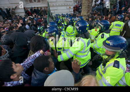 Police in riot gear resisting protestors on Whitehall, Day X Student Demonstration, 24 November 2010, London, England Stock Photo