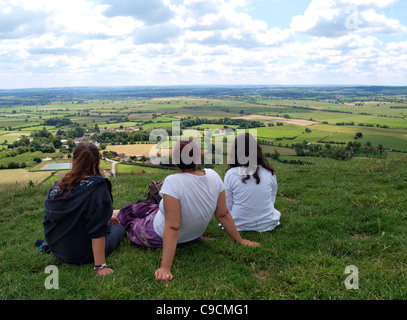 Family looking over the Somerset Levels from Glastonbury Tor, Somerset, UK Stock Photo